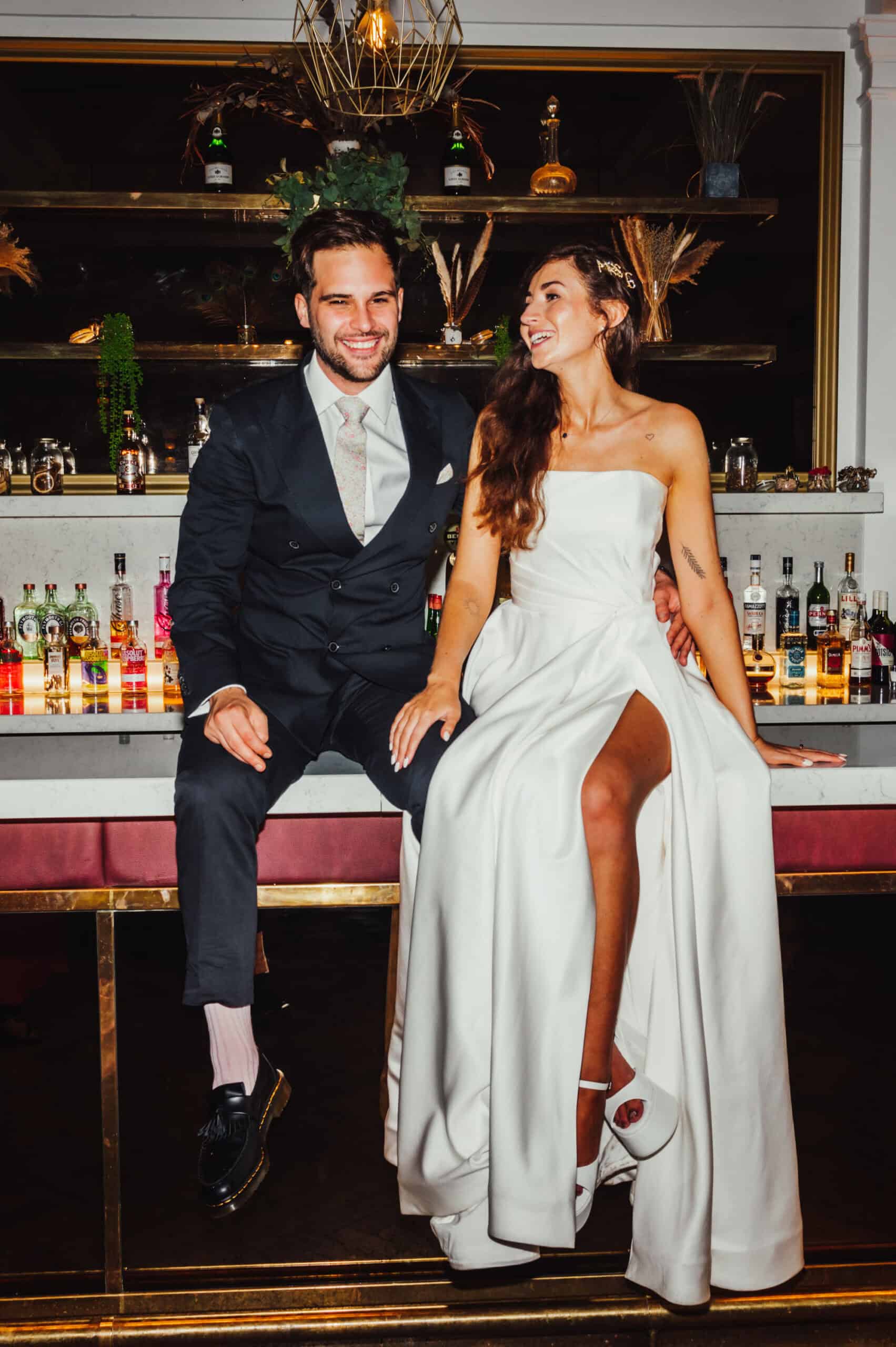 Indian fusion wedding couple in traditional attire, bride in embroidered lehenga with henna, groom in sherwani at Pelham House autumn wedding
