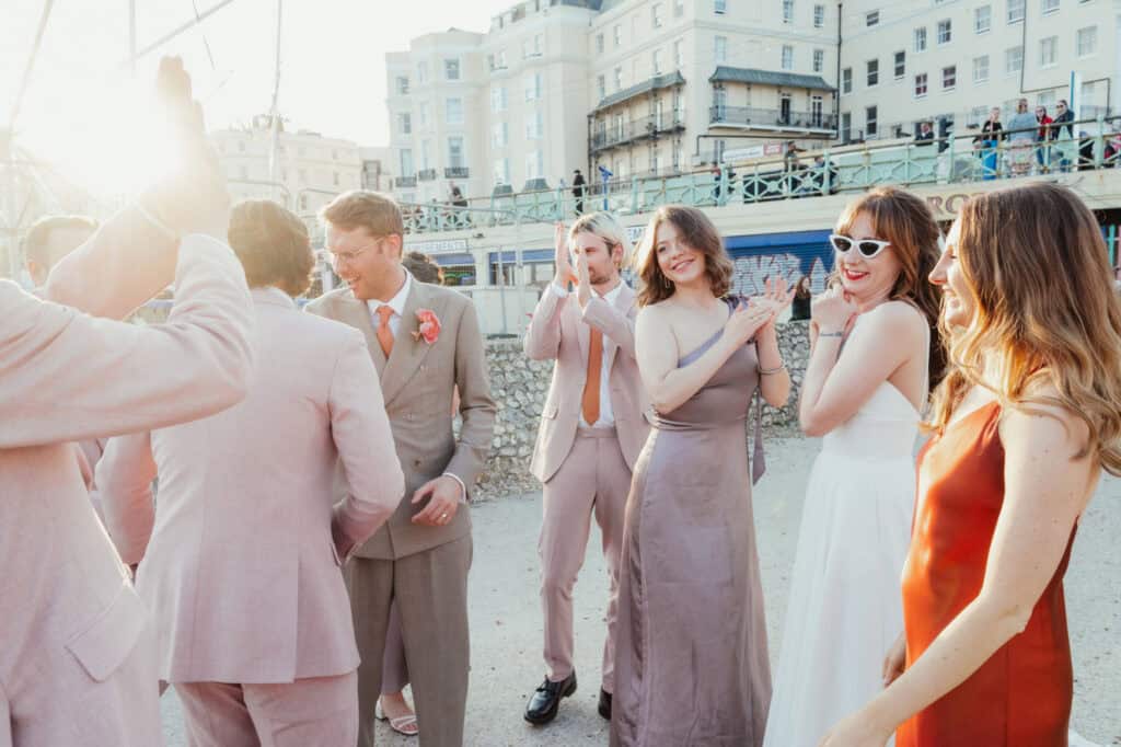 Vibrant seaside gathering with friends in fashionable attire, enjoying sunny day.