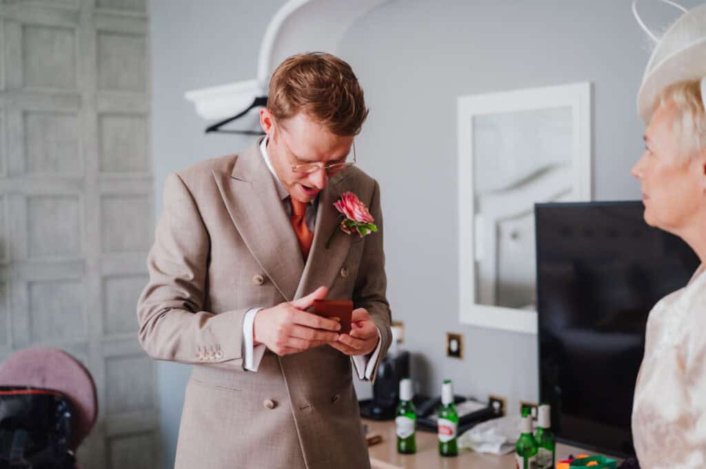Joyful man opening a present for a loved one.