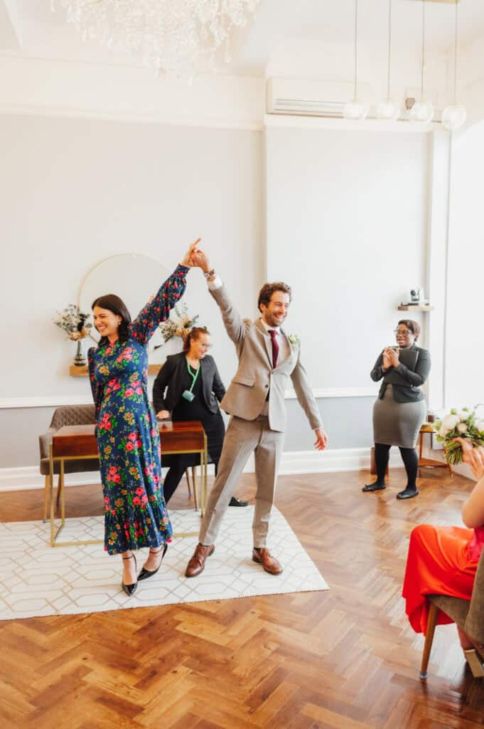 Happy newlyweds dancing together, joyful wedding celebration.