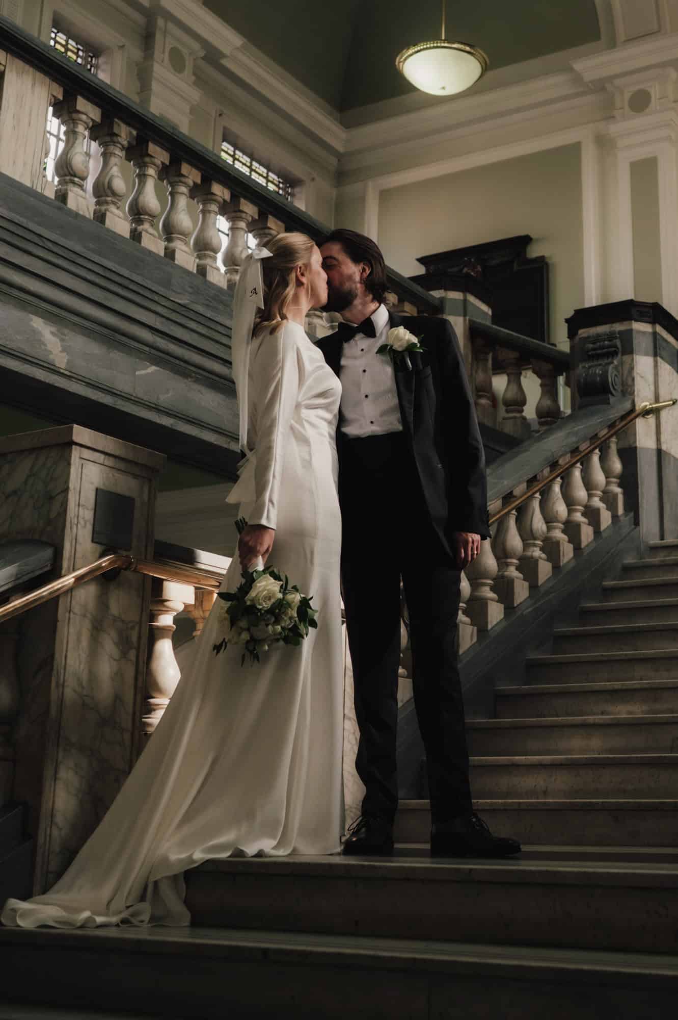 Intimate moment during London town hall registry office wedding ceremony, natural light documentary photography