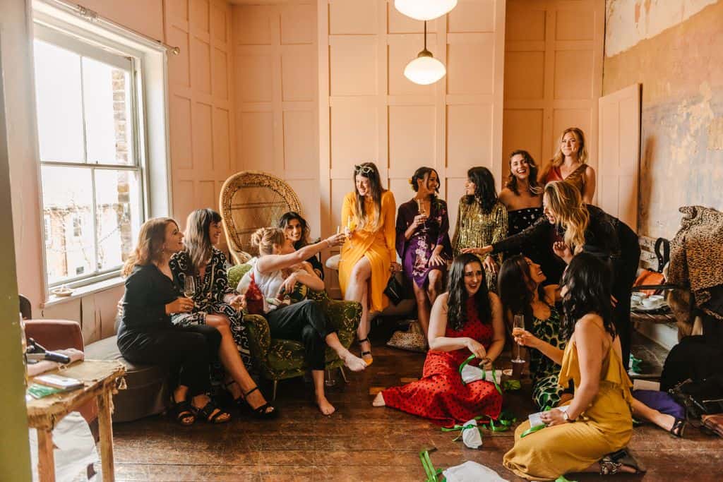Bridesmaids getting ready in colourful dresses