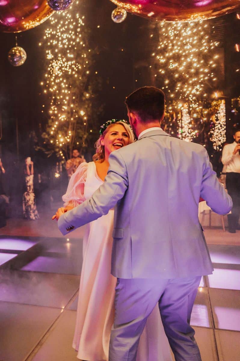 Couple dancing under sparklers at wedding reception