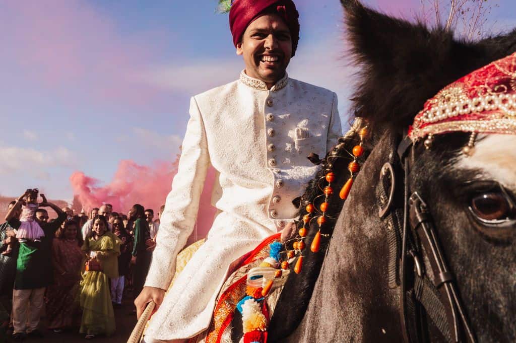 Groom arriving on horseback at Hindu wedding