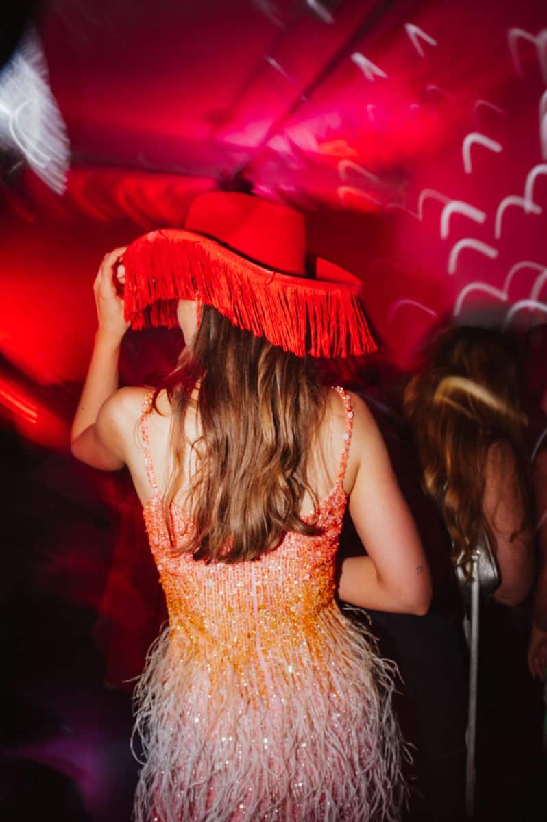 Guest dancing in sequin dress at wedding